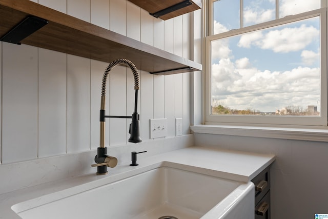 details featuring light countertops, white cabinets, and a sink