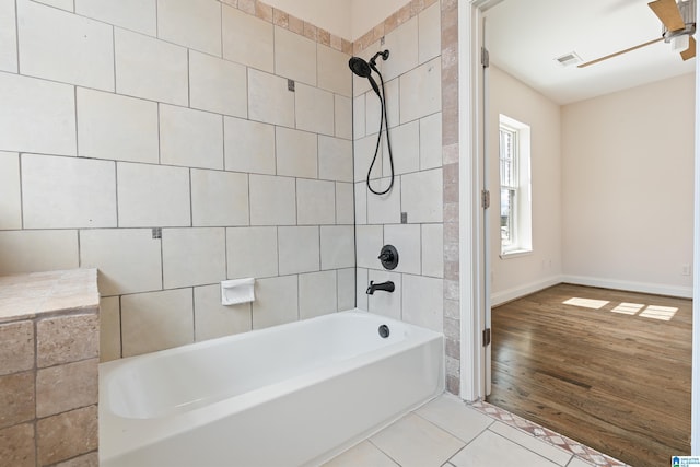 bathroom with a ceiling fan, visible vents, baseboards,  shower combination, and tile patterned flooring