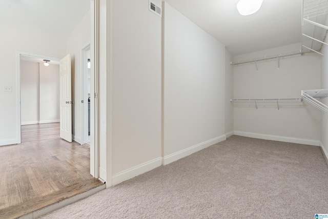 spacious closet featuring carpet and visible vents