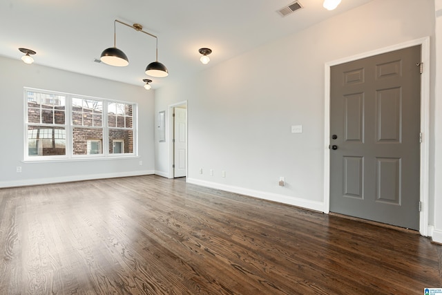 interior space featuring visible vents, baseboards, and dark wood-style flooring