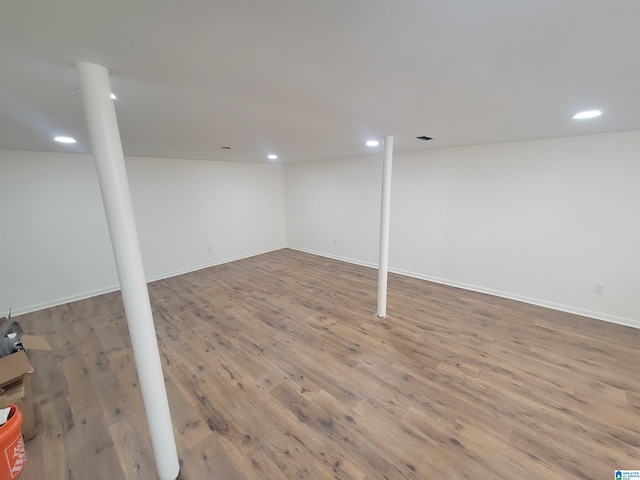 finished basement with recessed lighting, baseboards, and wood finished floors