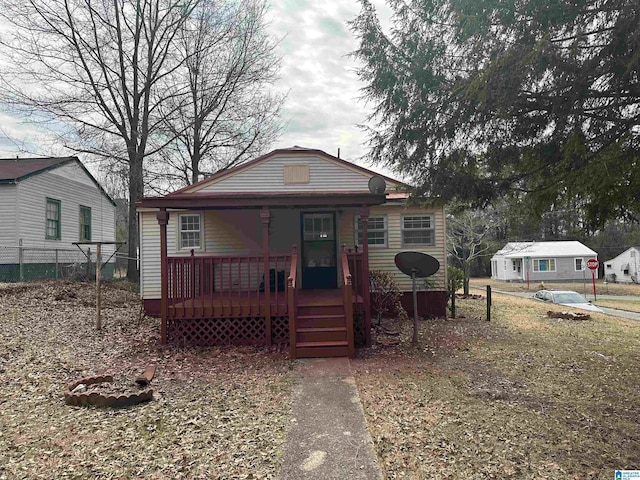 bungalow-style house with fence