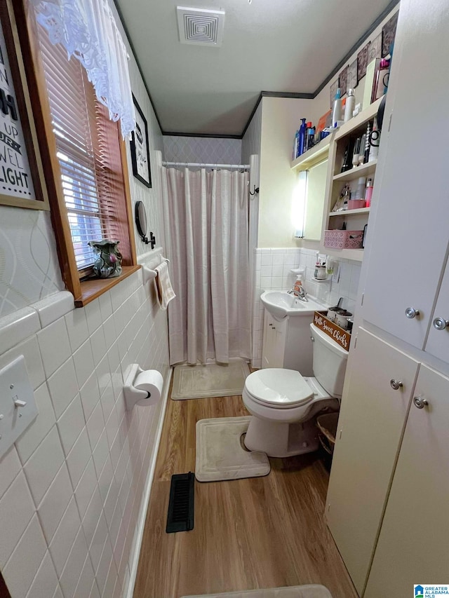 282 Stewart Rd, Cullman, AL 35055 - bathroom with visible vents, toilet, a shower with curtain, wood finished floors, and tile walls