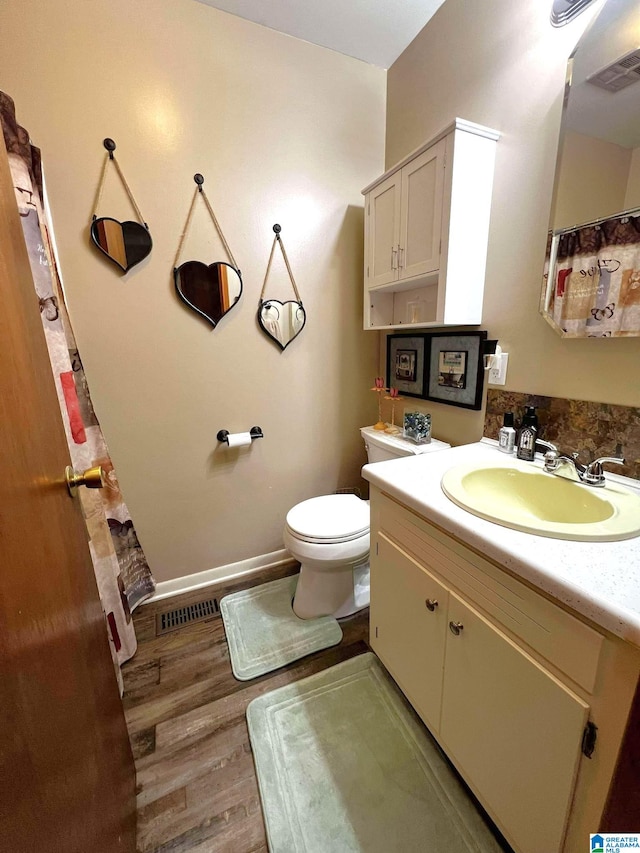 282 Stewart Rd, Cullman, AL 35055 - bathroom with visible vents, toilet, wood finished floors, and vanity