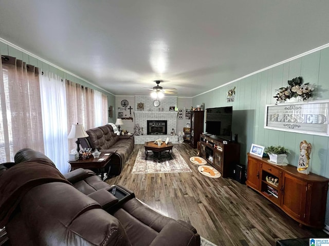 282 Stewart Rd, Cullman, AL 35055 - living area with a fireplace, crown molding, a ceiling fan, and dark wood-type flooring