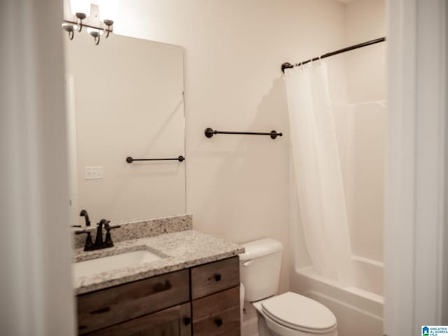 bathroom with toilet, shower / bath combo, and vanity