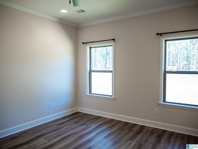 unfurnished room with visible vents, baseboards, dark wood-style flooring, and crown molding