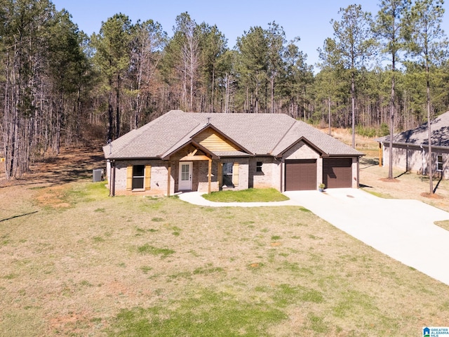 view of front of property featuring brick siding, an attached garage, concrete driveway, and a front lawn