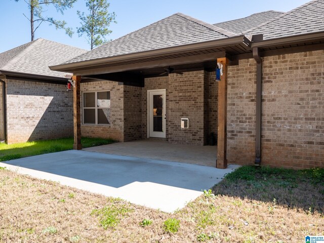 rear view of house featuring a patio, brick siding, a ceiling fan, and a shingled roof