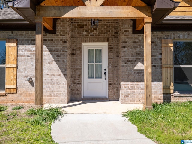 doorway to property with brick siding