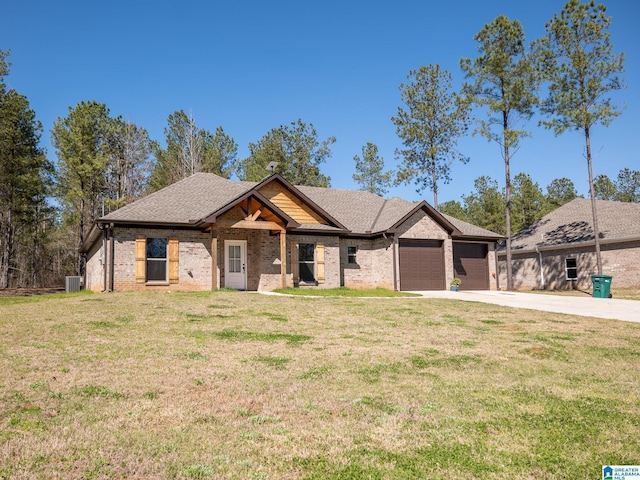 view of front of property featuring brick siding, a front lawn, central AC, a garage, and driveway