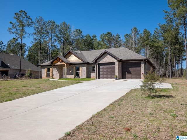 view of front facade with brick siding, driveway, a front yard, and a garage