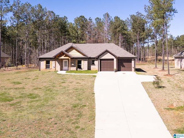 view of front of house with driveway, a front yard, covered porch, and an attached garage