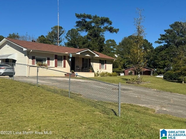 single story home with a front yard, driveway, and a fenced front yard