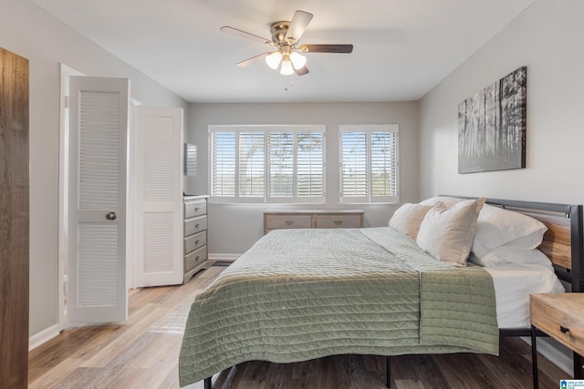 bedroom with light wood-type flooring, baseboards, and ceiling fan