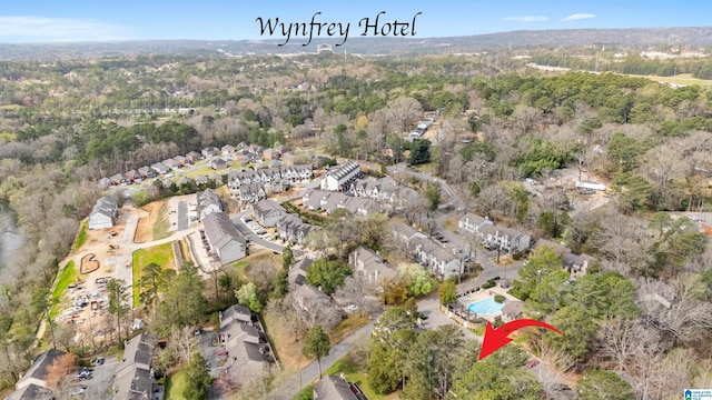 drone / aerial view featuring a residential view and a wooded view