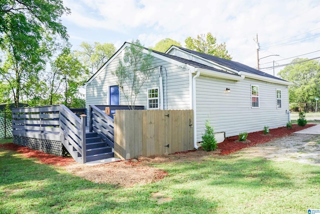3459 35th Ave N, Birmingham, AL 35207 - view of side of home featuring a wooden deck, a lawn, and fence