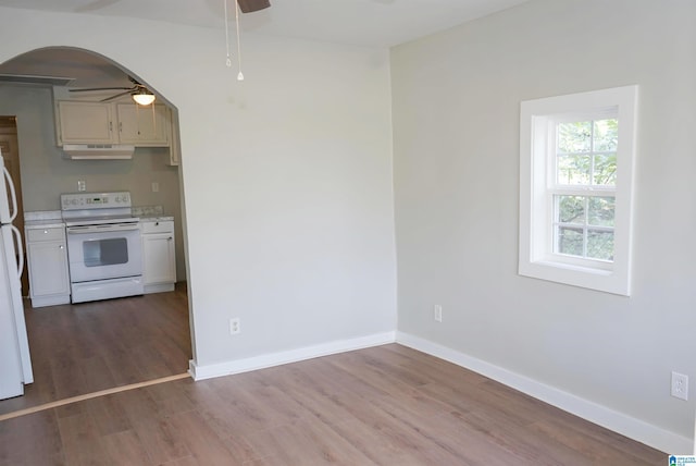 3459 35th Ave N, Birmingham, AL 35207 - kitchen with under cabinet range hood, white appliances, arched walkways, and a ceiling fan