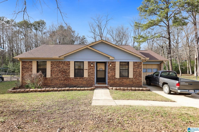 view of front facade with brick siding, an attached garage, concrete driveway, and a front yard