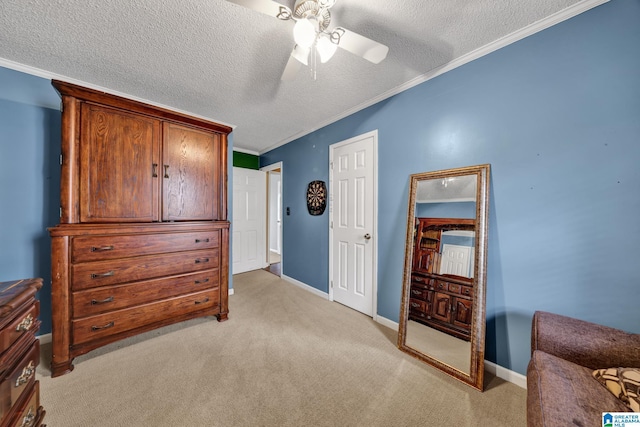 bedroom with baseboards, light carpet, a textured ceiling, and ornamental molding