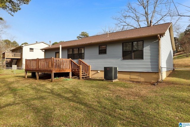 rear view of house with fence, roof with shingles, a yard, central AC, and a deck