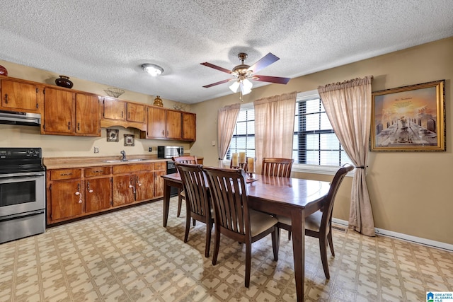 dining area with light floors, a textured ceiling, baseboards, and ceiling fan