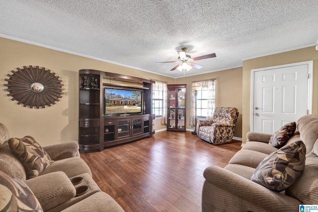 living room with a ceiling fan, crown molding, wood finished floors, and baseboards