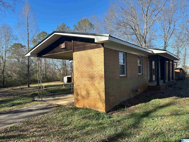 861 Lankford Ln, Alexandria, AL 36250 - view of side of home with a carport, a yard, brick siding, and aphalt driveway
