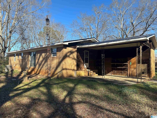 861 Lankford Ln, Alexandria, AL 36250 - rear view of house featuring a yard, an attached carport, brick siding, and entry steps