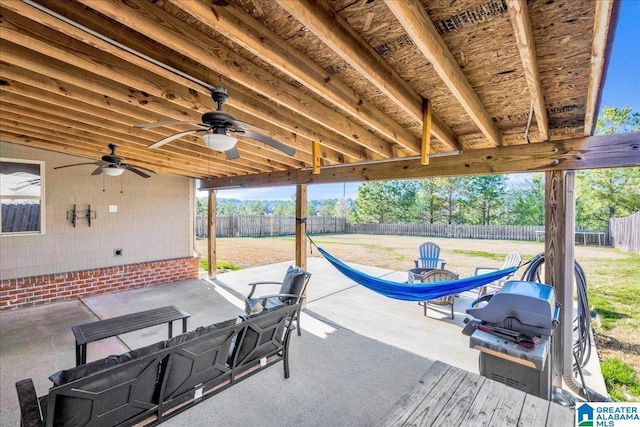 view of patio with ceiling fan, a grill, and a fenced backyard