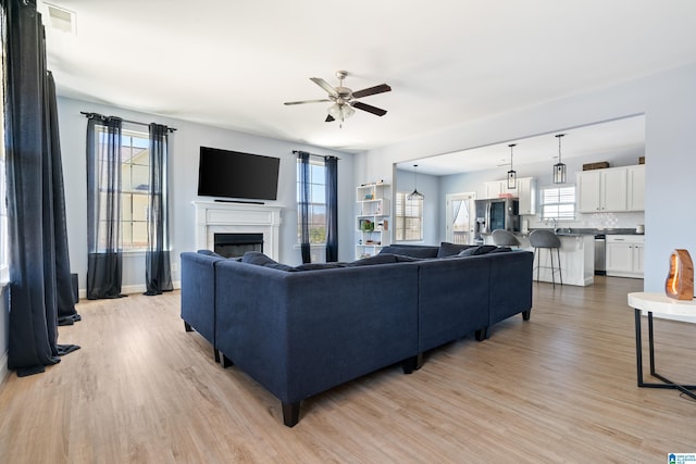 9266 Jardin Cir, Leeds, AL 35094 - living room with a ceiling fan, light wood finished floors, and plenty of natural light
