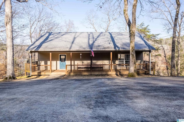 view of front facade with covered porch and metal roof