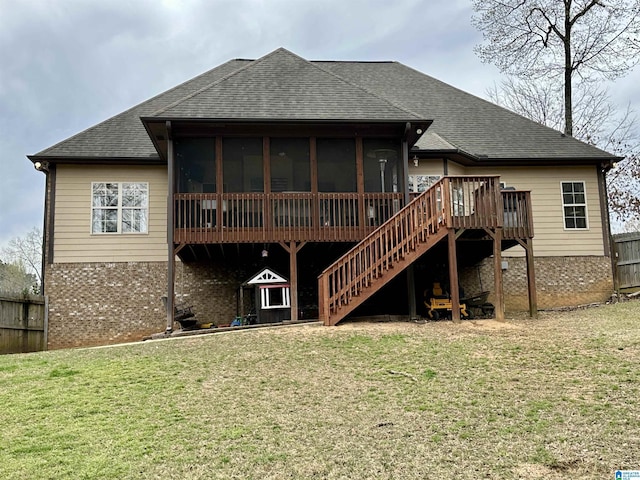 rear view of property featuring a lawn, brick siding, stairway, and roof with shingles