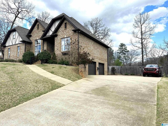 view of home's exterior with brick siding, concrete driveway, and a garage