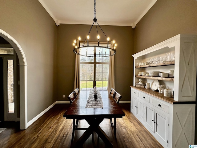dining room featuring arched walkways, baseboards, a chandelier, and dark wood-type flooring