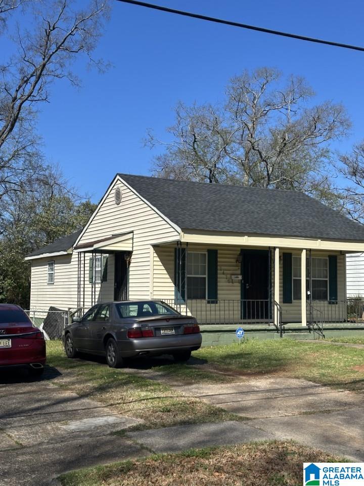 bungalow featuring a porch and a shingled roof