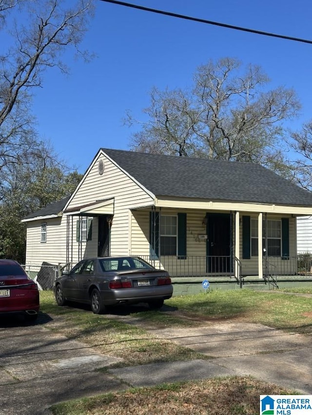 bungalow featuring a porch and a shingled roof