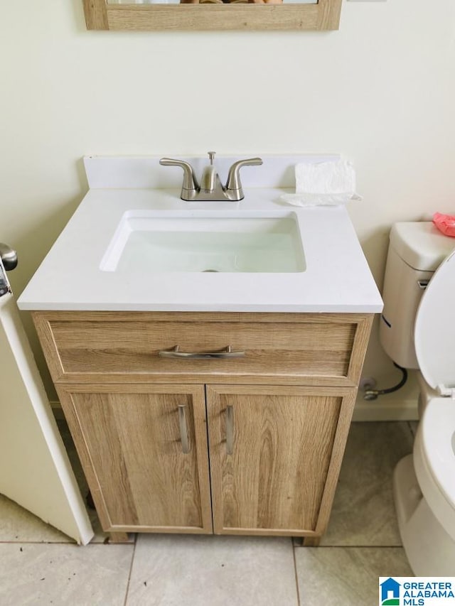 bathroom featuring tile patterned floors, toilet, and vanity