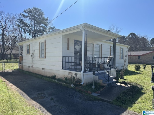 bungalow featuring crawl space, a front yard, and fence