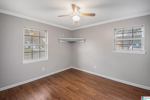 unfurnished room with dark wood-type flooring, crown molding, and baseboards