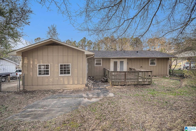 back of property featuring fence, french doors, and a wooden deck