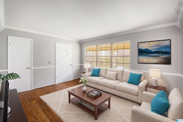 living room with crown molding and wood finished floors