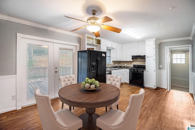 dining space featuring french doors, light wood-type flooring, crown molding, and ceiling fan