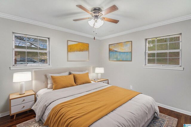 bedroom with crown molding, baseboards, and wood finished floors