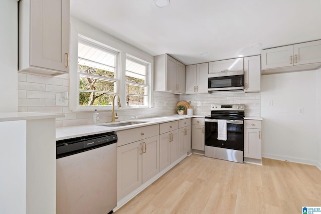 264 Mccalla Rd, Birmingham, AL 35022 - kitchen with light countertops, decorative backsplash, appliances with stainless steel finishes, light wood-style floors, and a sink