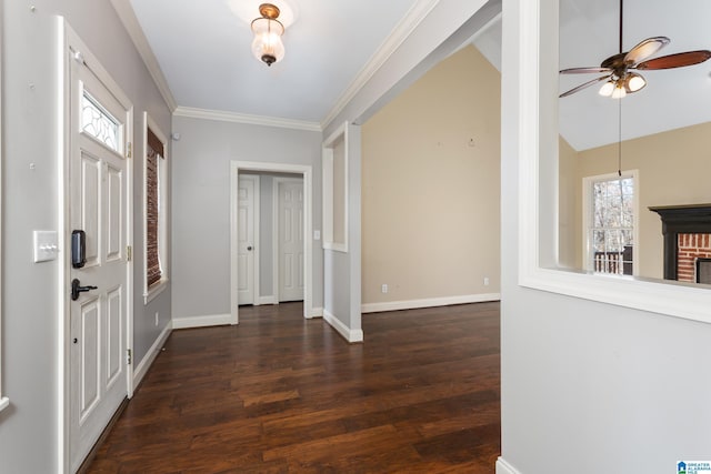foyer entrance with baseboards, wood finished floors, a ceiling fan, and ornamental molding