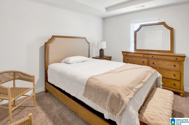 carpeted bedroom featuring baseboards and visible vents