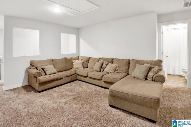 living room with visible vents, carpet flooring, and baseboards