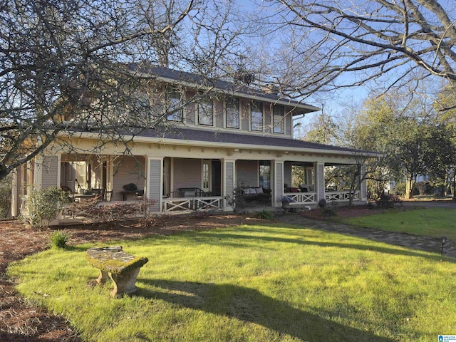 farmhouse featuring covered porch and a front yard
