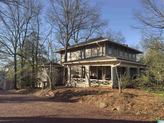 view of front of property with covered porch and a chimney